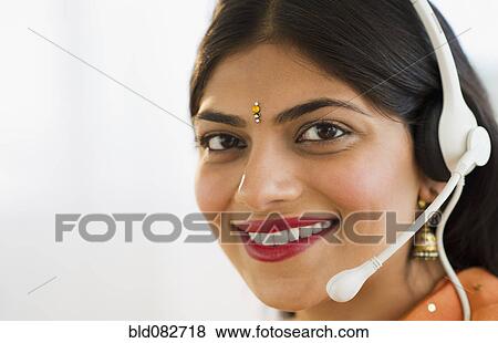 Mixed race woman in traditional Indian clothing talking on headset View Large Photo Image Stock Photo - Mixed race woman in traditional Indian clothing talking on headset. Fotosearch