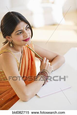 Mixed race woman in traditional Indian clothing thinking View Large Photo Image Stock Photography - Mixed race woman in traditional Indian clothing thinking. Fotosearch
