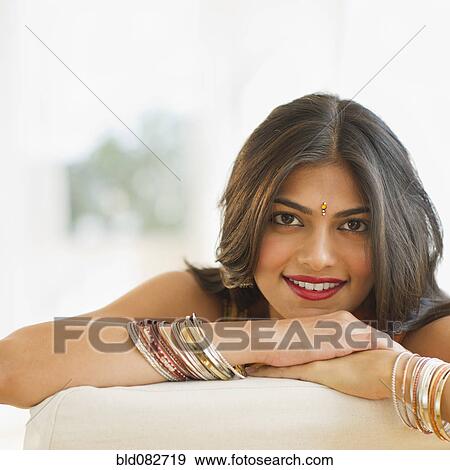 Stock Photo - Mixed race woman wearing bindi and bangles. Fotosearch