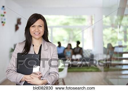 Stock Image - Real estate agent showing family new home. Fotosearch