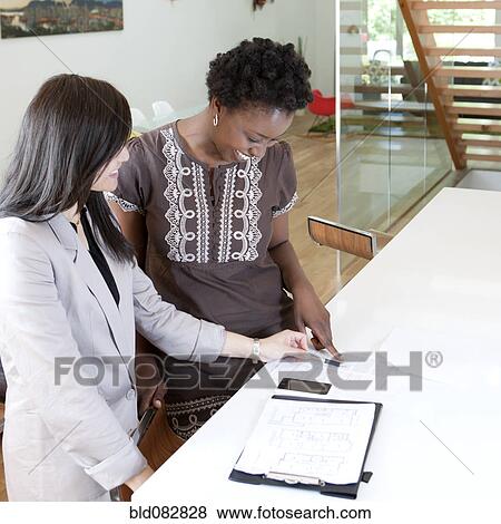 Real estate agent talking to prospective buyer View Large Photo Image Stock Photo - Real estate agent talking to prospective buyer. Fotosearch