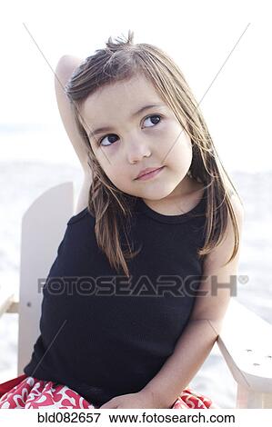 Serious Hispanic girl sitting on beach View Large Photo Image Stock Photo - Serious Hispanic girl sitting on beach. Fotosearch