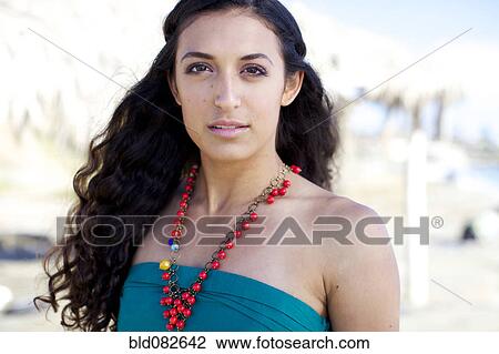 Serious mixed race woman wearing necklace View Large Photo Image Stock Image - Serious mixed race woman wearing necklace. Fotosearch