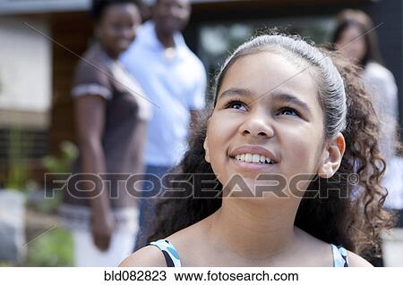 Stock Image - Smiling mixed race girl looking up. Fotosearch
