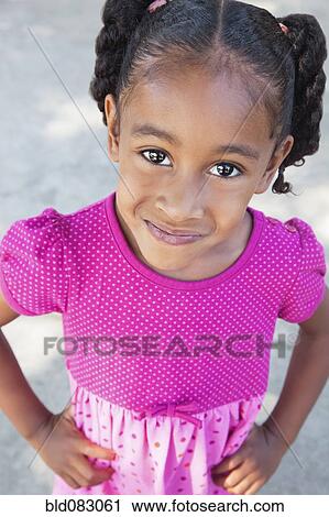 Smiling mixed race girl with hands on hips View Large Photo Image Stock Image - Smiling mixed race girl with hands on hips. Fotosearch