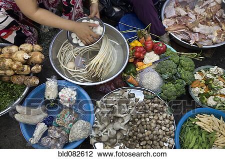 Vietnamese woman sitting with vegetables View Large Photo Image Stock Image - Vietnamese woman sitting with vegetables. Fotosearch