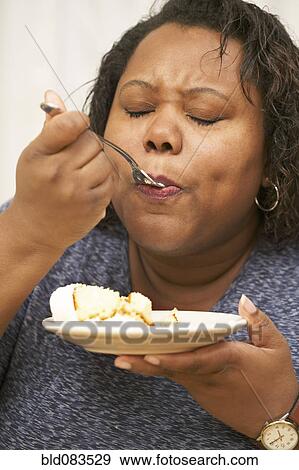 African American enjoying a piece of cake View Large Photo Image Stock Photo - African American enjoying a piece of cake. Fotosearch
