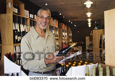 African American small business owner working in wine shop View Large Photo Image Stock Image - African American small business owner working in wine shop. Fotosearch