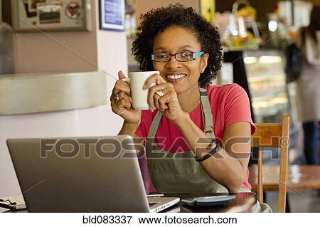 Stock Photo - African American small business owner in shop. Fotosearch