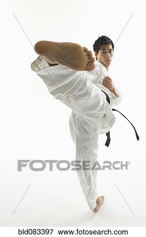 Asian male karate black belt kicking in air View Large Photo Image Stock Photo - Asian male karate black belt kicking in air. Fotosearch