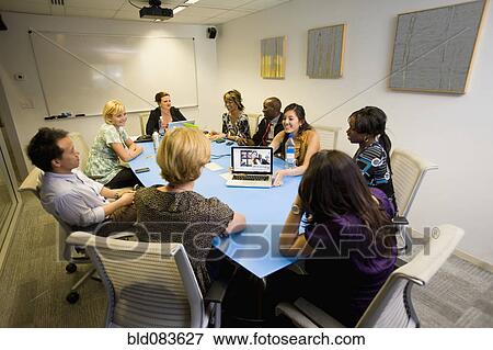 Stock Photo - Business people having meeting in conference room. Fotosearch
