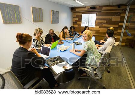 Stock Photo - Business people having meeting in conference room. Fotosearch
