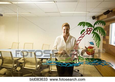 Caucasian businesswoman looking at vacation drawing on conference room wall View Large Photo Image Stock Image - Caucasian businesswoman looking at vacation drawing on conference room wall. Fotosearch