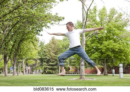 Stock Photography - Caucasian man balancing on rope in park. Fotosearch