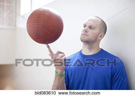 Caucasian man spinning basketball on finger View Large Photo Image Stock Image - Caucasian man spinning basketball on finger. Fotosearch