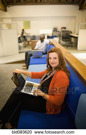 Caucasian woman using laptop in modern office View Large Photo Image Stock Image - Caucasian woman using laptop in modern office. Fotosearch