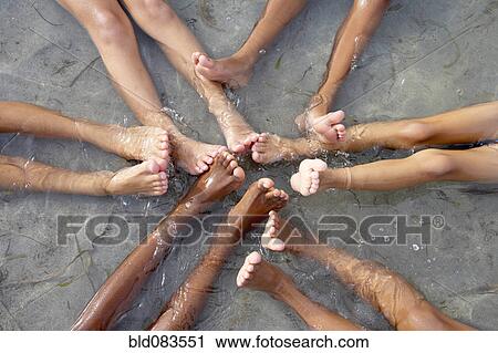 Children with feet together in water View Large Photo Image Stock Image - Children with feet together in water. Fotosearch