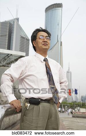 Chinese businessman standing outdoors View Large Photo Image Stock Image - Chinese businessman standing outdoors. Fotosearch