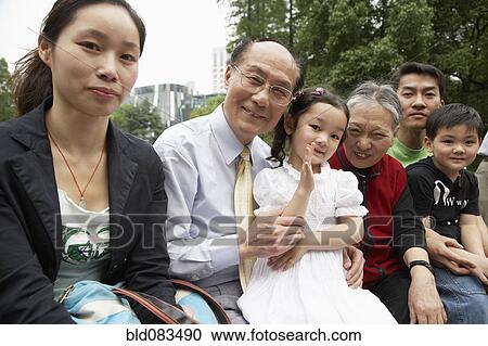 Chinese family sitting together outdoors View Large Photo Image Stock Image - Chinese family sitting together outdoors. Fotosearch