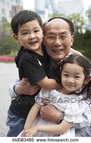 Stock Photo - Chinese grandfather and grandchildren smiling. Fotosearch