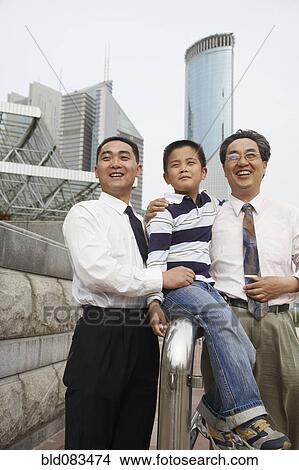 Chinese grandfather, father and son together outdoors View Large Photo Image Picture - Chinese grandfather, father and son together outdoors. Fotosearch