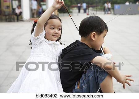 Chinese sister pulling brothers hair View Large Photo Image Stock Image - Chinese sister pulling brothers hair. Fotosearch
