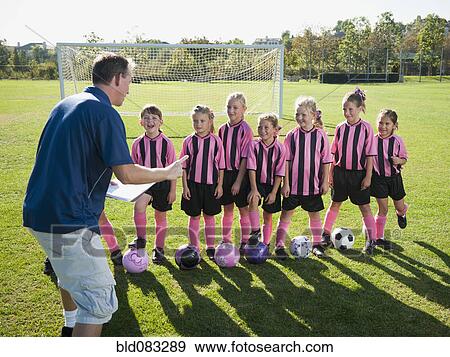 Coach motivating girl soccer players View Large Photo Image Stock Photo - Coach motivating girl soccer players. Fotosearch