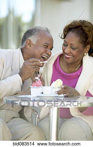 Picture - Couple eating ice cream together. Fotosearch
