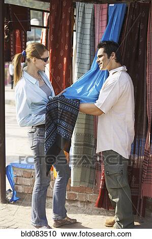 Customer looking at fabric in market View Large Photo Image Stock Image - Customer looking at fabric in market. Fotosearch