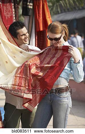Customer looking at fabric in market View Large Photo Image Stock Image - Customer looking at fabric in market. Fotosearch