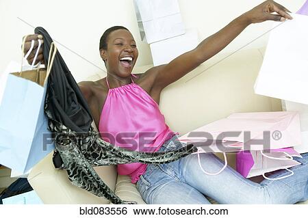 Excited African American woman with shopping bags View Large Photo Image Stock Photograph - Excited African American woman with shopping bags. Fotosearch