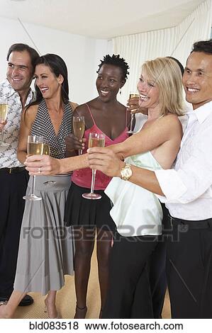 Friends celebrating with Champagne together View Large Photo Image Stock Photo - Friends celebrating with Champagne together. Fotosearch