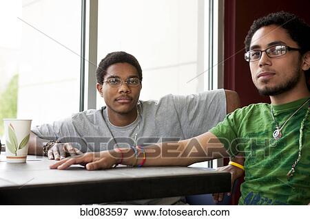 Stock Photo - Friends hanging out in cafe. Fotosearch