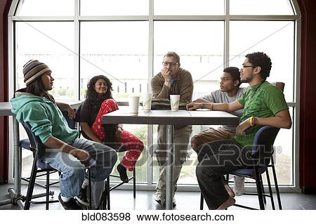 Stock Photo - Friends hanging out in cafe. Fotosearch