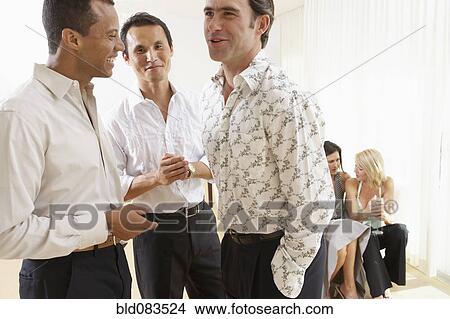 Picture - Friends talking at party together. Fotosearch