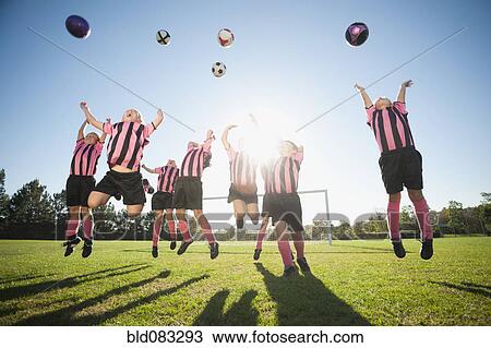 Stock Image - Girl soccer players practicing with soccer balls. Fotosearch