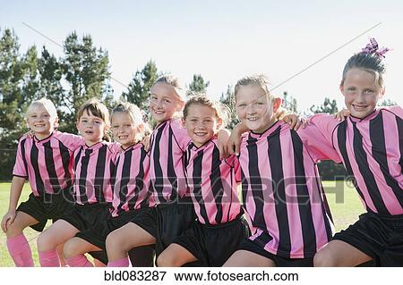 Stock Photo - Girl soccer players standing in a row. Fotosearch