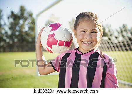Hispanic girl soccer player holding soccer ball View Large Photo Image Stock Photo - Hispanic girl soccer player holding soccer ball. Fotosearch