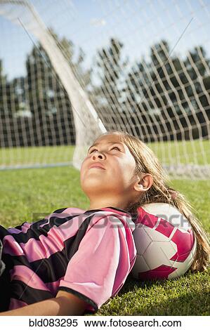 Hispanic girl soccer player laying with head on soccer ball View Large Photo Image Stock Photography - Hispanic girl soccer player laying with head on soccer ball. Fotosearch