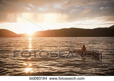 Hispanic woman kayaking on lake View Large Photo Image Picture - Hispanic woman kayaking on lake. Fotosearch