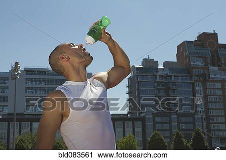 Mixed race athlete drinking water View Large Photo Image Stock Image - Mixed race athlete drinking water. Fotosearch