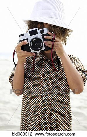Mixed race boy using old-fashioned camera View Large Photo Image Stock Image - Mixed race boy using old-fashioned camera. Fotosearch
