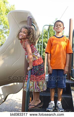 Mixed race children playing on playground View Large Photo Image Stock Photo - Mixed race children playing on playground. Fotosearch