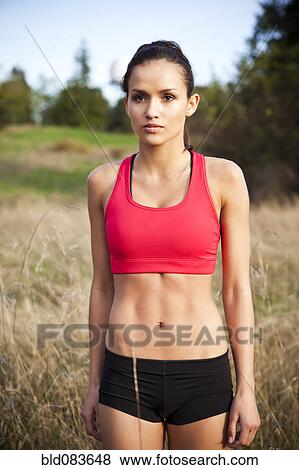 Mixed race jogger standing in field View Large Photo Image Stock Photo - Mixed race jogger standing in field. Fotosearch