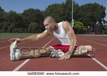 Mixed race runner stretching before race View Large Photo Image Stock Image - Mixed race runner stretching before race. Fotosearch