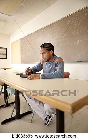 Stock Photography - Peruvian student studying in classroom on laptop. Fotosearch