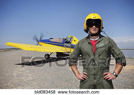 Stock Photo - Pilot standing near small airplane. Fotosearch