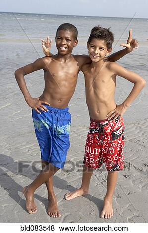 Stock Photo - Playful boys enjoying the beach together. Fotosearch