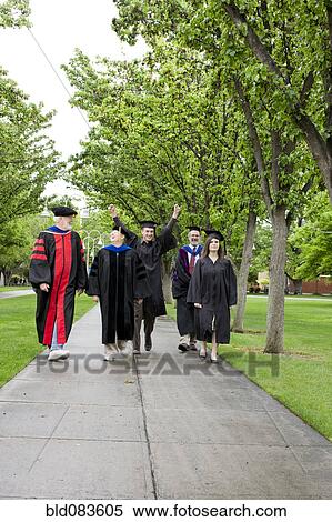 Stock Photography - Professors and students walking to graduation. Fotosearch