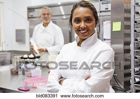 Small business owners working in bakery kitchen View Large Photo Image Stock Image - Small business owners working in bakery kitchen. Fotosearch